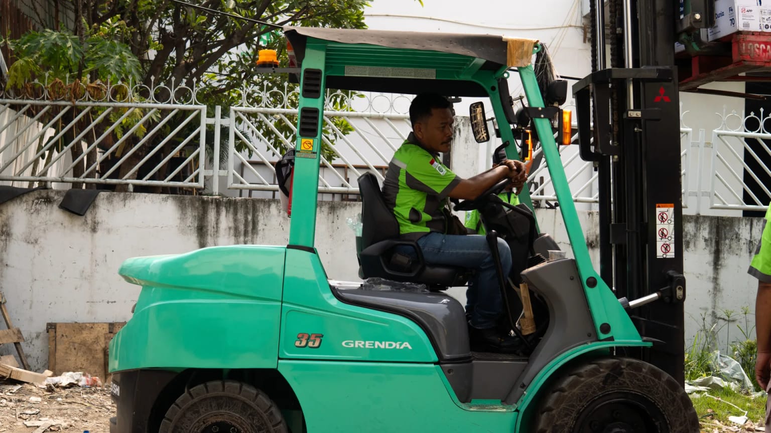 Operator moving cargo with a forklift at the depot