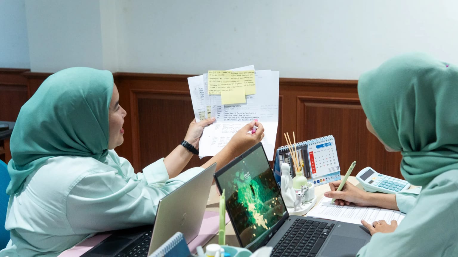 Staff reviewing shipment documents at the office