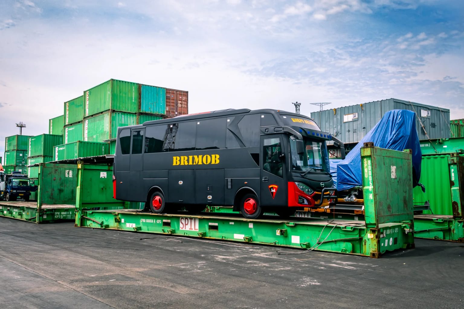 Korps Brimob bus loaded on a flat rack container