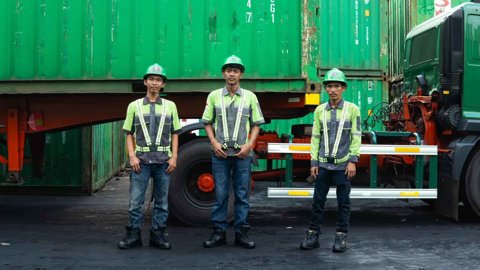 BSB crew in safety gear in front of a container truck